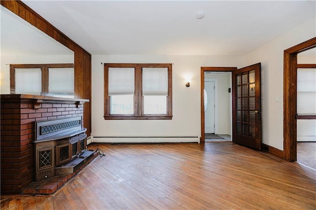 living room with hardwood / wood-style flooring, a baseboard radiator, a baseboard heating unit, and baseboards