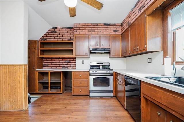 kitchen featuring light countertops, gas stove, light wood-type flooring, dishwasher, and under cabinet range hood