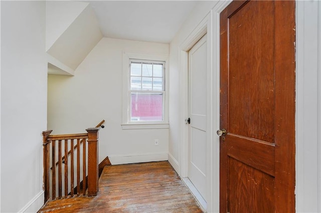 additional living space featuring lofted ceiling, baseboards, and wood finished floors