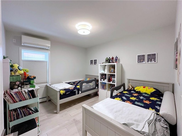 bedroom with a wall unit AC, light wood finished floors, and a baseboard radiator