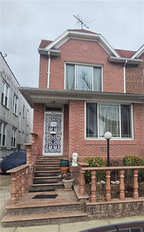 view of front of home featuring brick siding