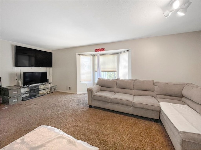 living area featuring carpet floors and baseboards