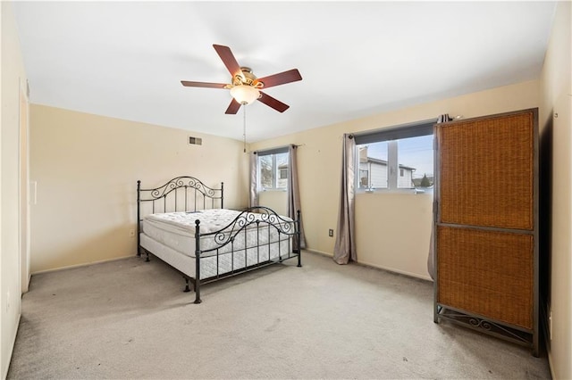 bedroom featuring a ceiling fan and light carpet