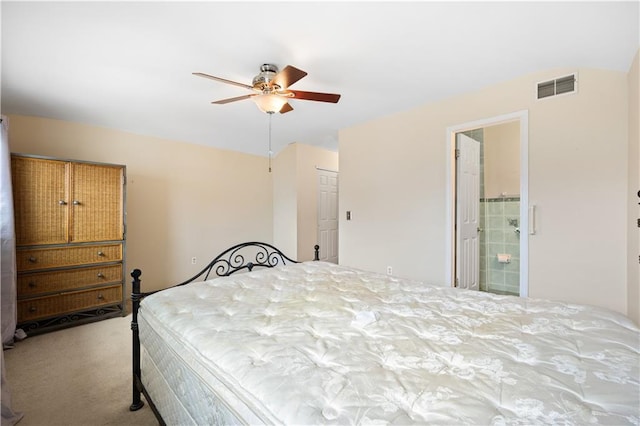 carpeted bedroom with a closet, visible vents, ceiling fan, and ensuite bathroom