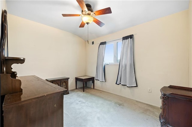 interior space featuring light carpet, ceiling fan, vaulted ceiling, and visible vents