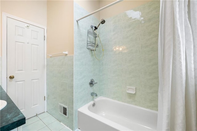 full bath with shower / tub combo, tile patterned flooring, visible vents, and tile walls