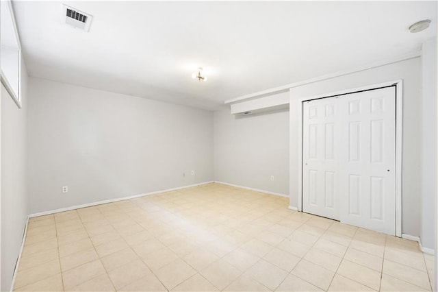 unfurnished bedroom with baseboards, visible vents, and a closet