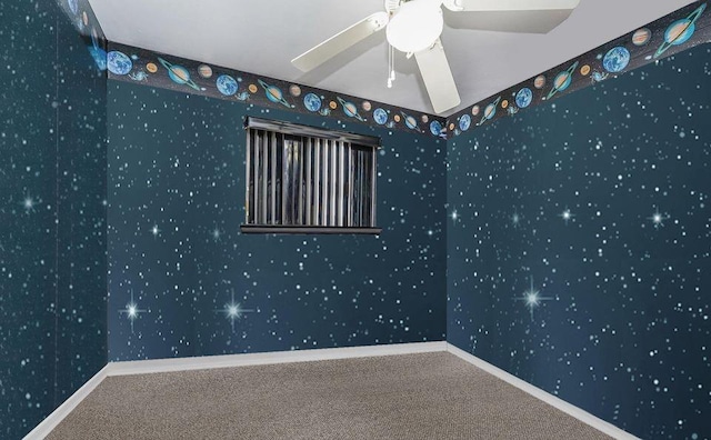 spare room featuring carpet, ceiling fan, baseboards, and wallpapered walls