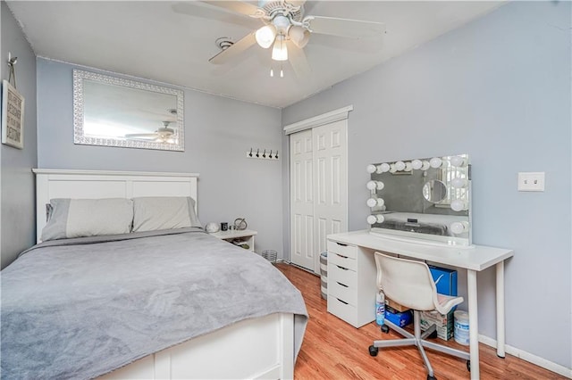 bedroom with a closet, ceiling fan, baseboards, and wood finished floors