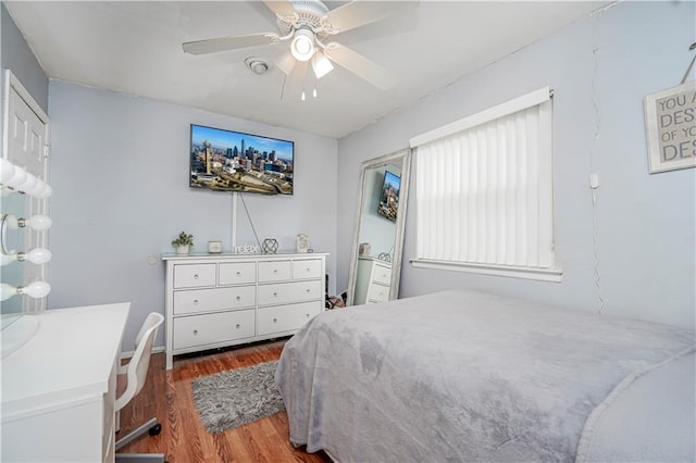 bedroom with wood finished floors and a ceiling fan