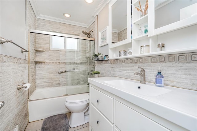 bathroom with toilet, shower / bath combination with glass door, crown molding, vanity, and tile walls