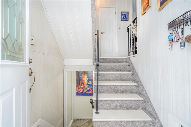 stairs featuring wood finished floors and visible vents