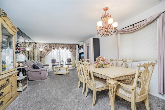 dining space featuring a chandelier and carpet floors