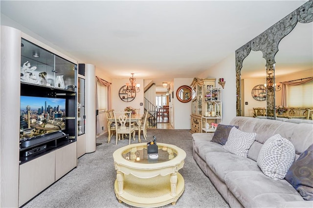 living area with stairs, a notable chandelier, and light colored carpet