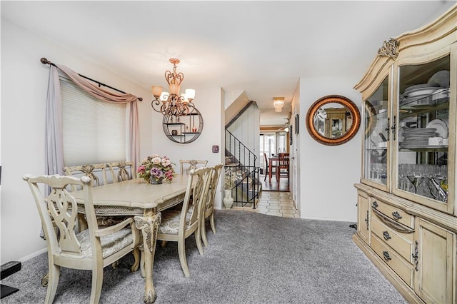 carpeted dining area featuring a chandelier and stairway