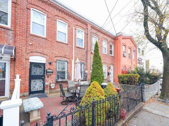 multi unit property featuring fence and brick siding