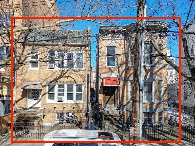 exterior space with entry steps and a fenced front yard