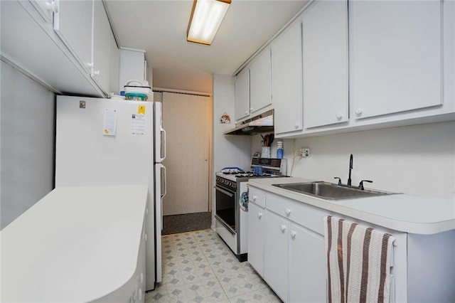 kitchen featuring under cabinet range hood, light countertops, a sink, and range with gas cooktop