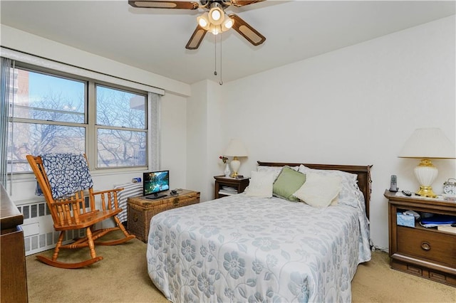 bedroom with carpet, ceiling fan, and radiator heating unit