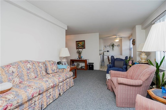 carpeted living area with ceiling fan and plenty of natural light