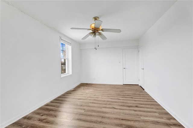 empty room with ceiling fan and wood finished floors