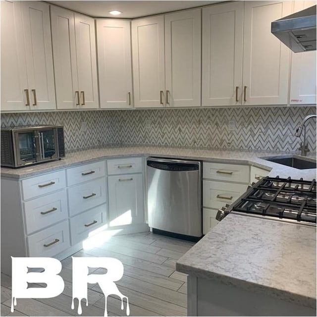 kitchen featuring backsplash, under cabinet range hood, dishwasher, stove, and a sink