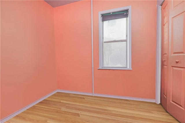 spare room with light wood-style flooring and baseboards