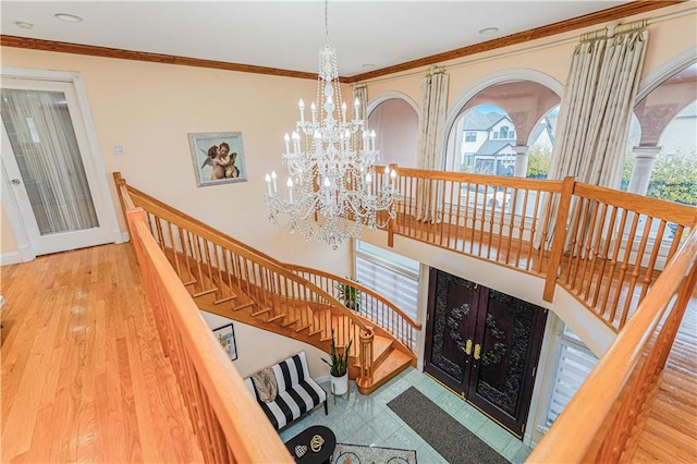 90 Giegerich Ave, Staten Island, NY 10307 - stairs featuring a chandelier, plenty of natural light, wood finished floors, ornamental molding, and baseboards