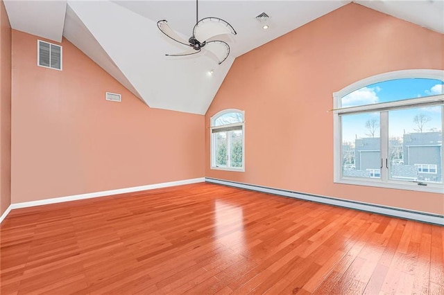 90 Giegerich Ave, Staten Island, NY 10307 - unfurnished living room featuring vaulted ceiling, light wood finished floors, baseboard heating, and baseboards