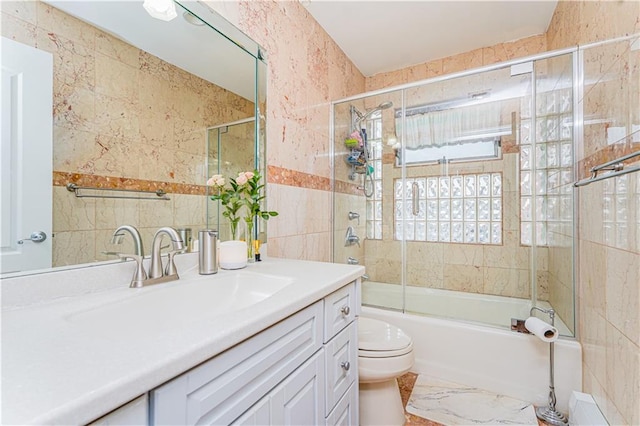 90 Giegerich Ave, Staten Island, NY 10307 - bathroom featuring vanity, tile walls, toilet, bath / shower combo with glass door, and marble finish floors