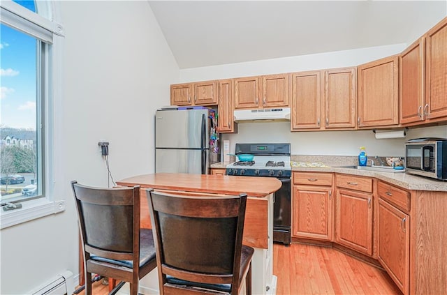90 Giegerich Ave, Staten Island, NY 10307 - kitchen with under cabinet range hood, appliances with stainless steel finishes, light countertops, a baseboard radiator, and light wood-style floors