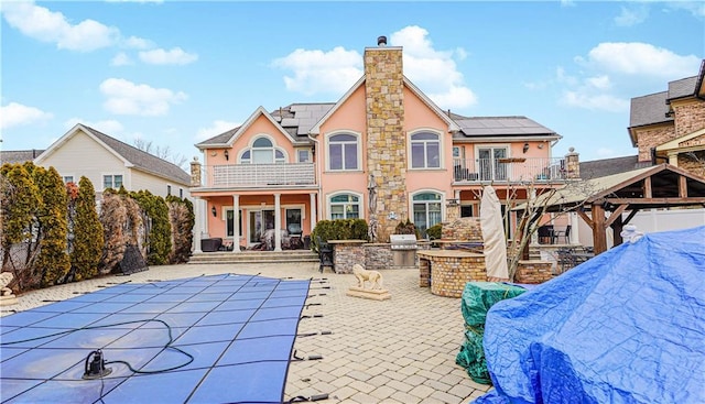 90 Giegerich Ave, Staten Island, NY 10307 - back of property featuring a balcony, area for grilling, stucco siding, a patio area, and solar panels