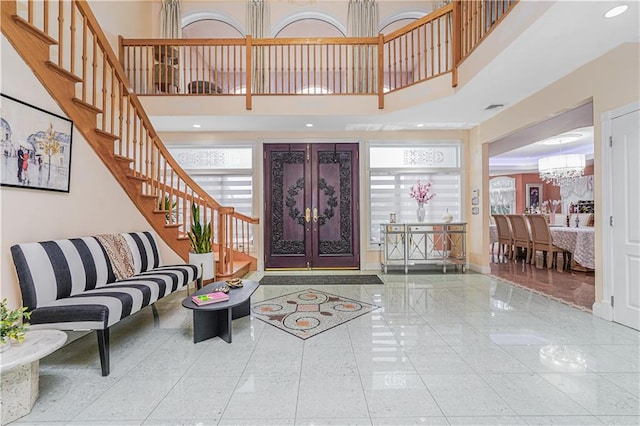 90 Giegerich Ave, Staten Island, NY 10307 - entrance foyer with a towering ceiling, a chandelier, stairs, baseboards, and french doors