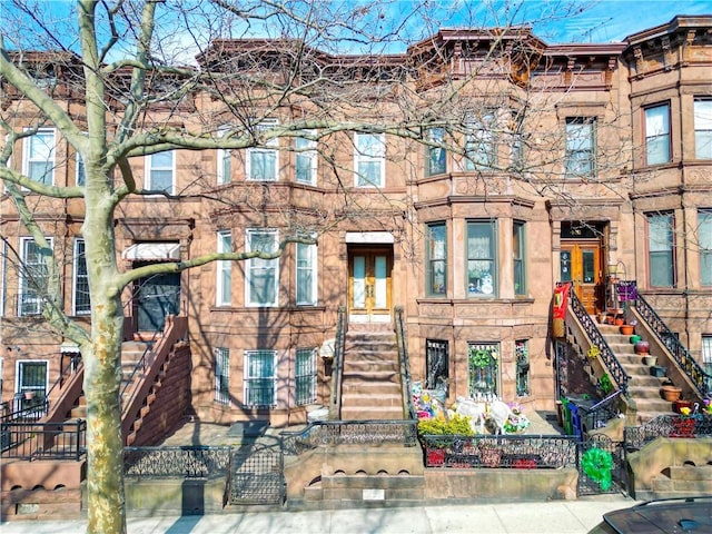 view of front of house featuring a fenced front yard and stairs