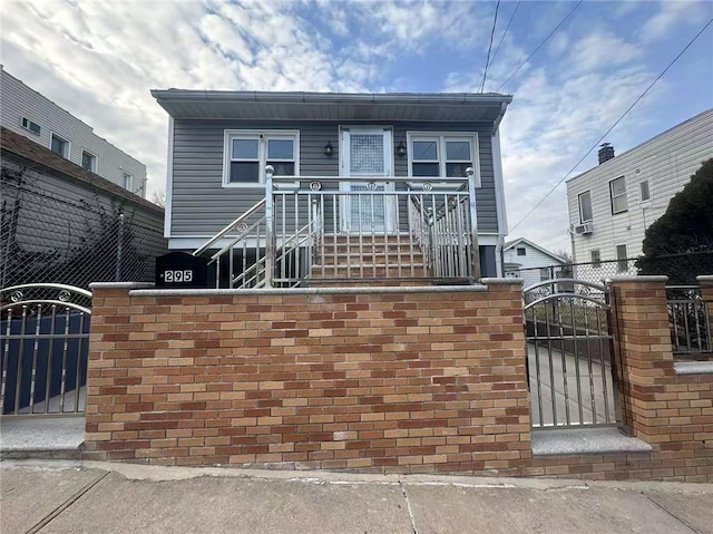 view of front of property featuring a gate and fence