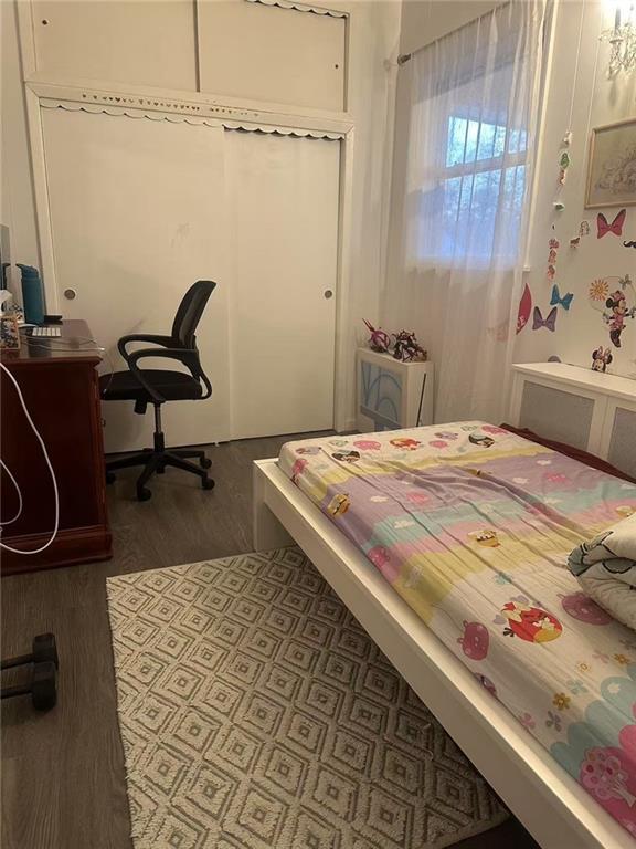 bedroom with wood finished floors