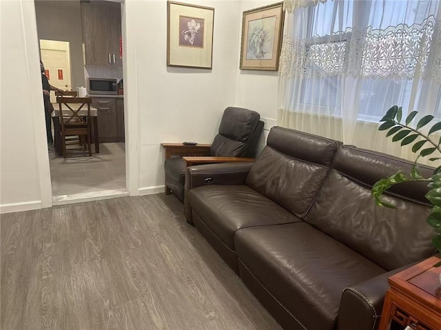 sitting room featuring baseboards and dark wood-style floors