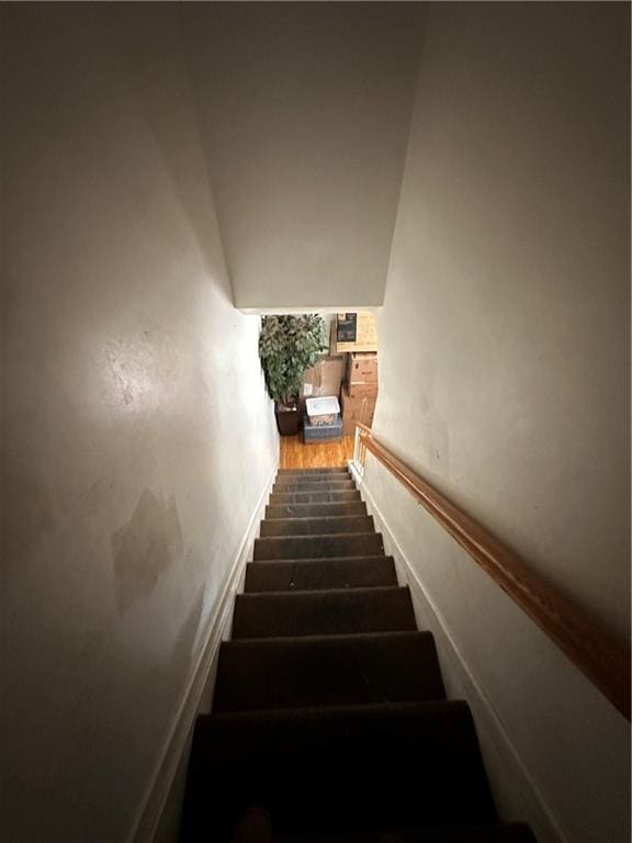 staircase with wood finished floors