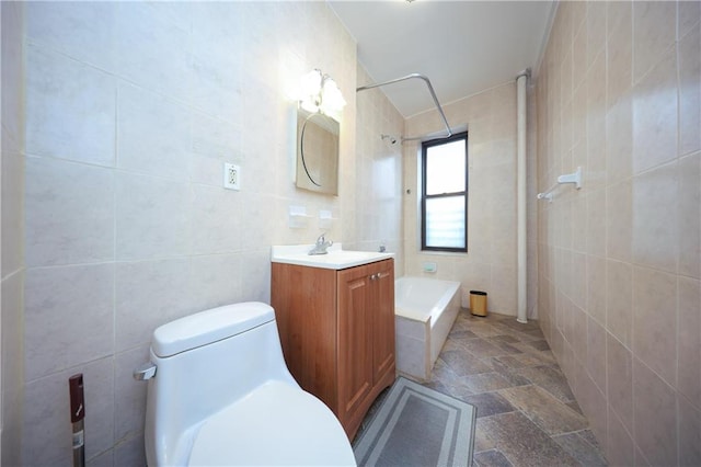 full bath featuring vanity, tile walls, toilet, and stone tile flooring