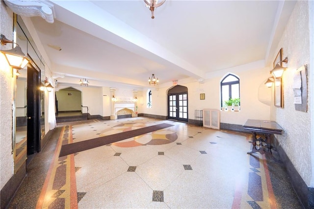 exercise room featuring french doors and baseboards