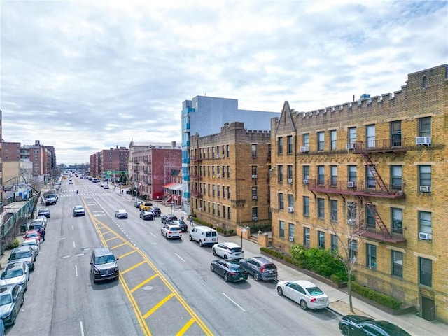 exterior space featuring curbs, sidewalks, and street lighting