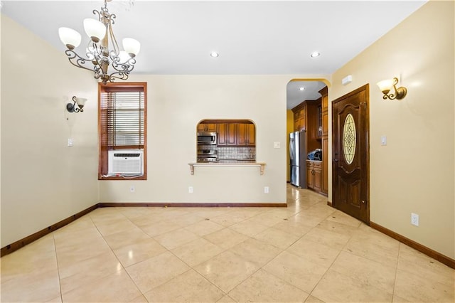 unfurnished room with a notable chandelier, recessed lighting, baseboards, and cooling unit