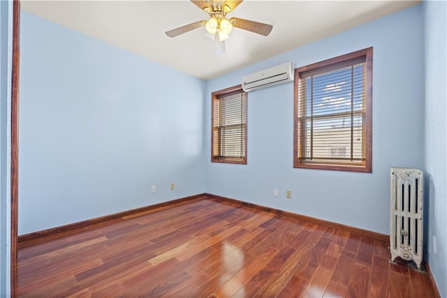 empty room with a wall mounted AC, baseboards, radiator heating unit, and dark wood-type flooring