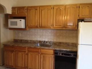 737 E 48th St, Brooklyn, NY 11203 - kitchen featuring white appliances, tasteful backsplash, and stone counters