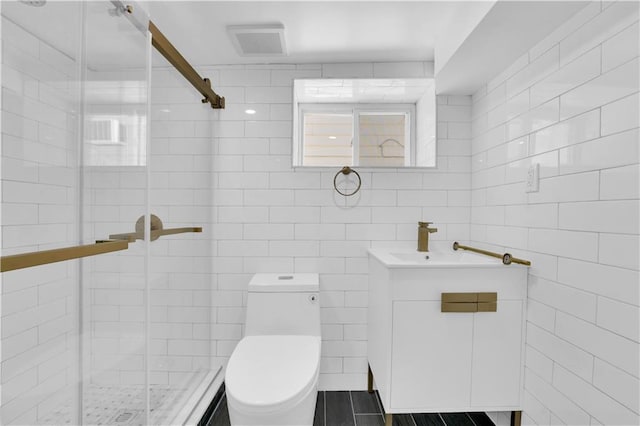 bathroom with vanity, a shower stall, toilet, and visible vents