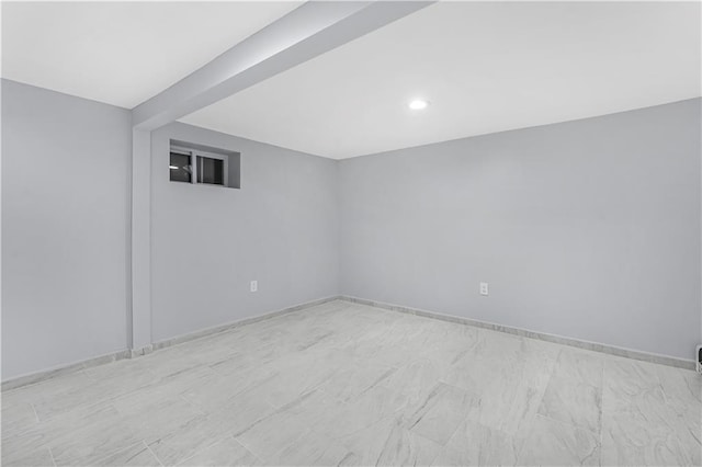 spare room featuring baseboards