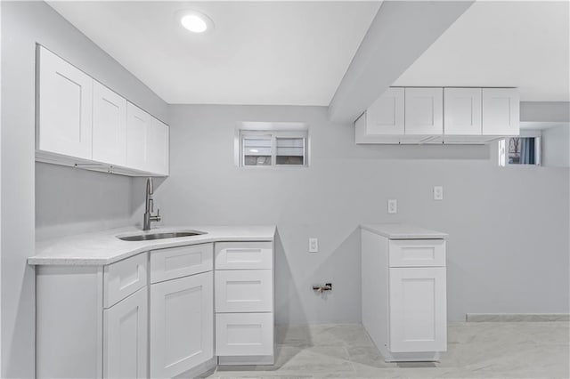 laundry area with a sink and cabinet space