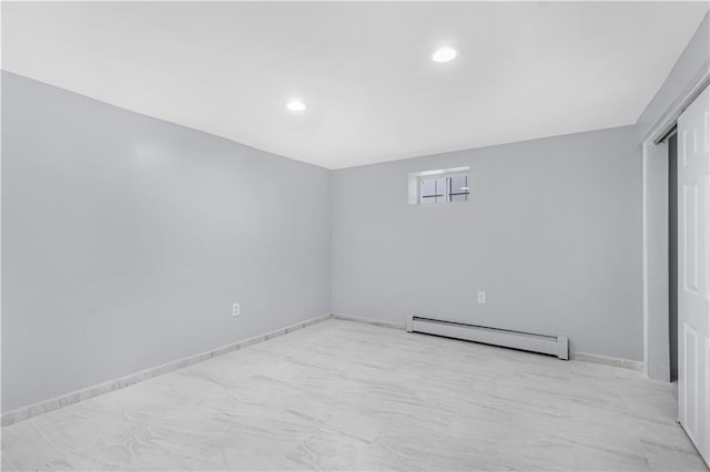 empty room featuring recessed lighting, baseboards, and baseboard heating