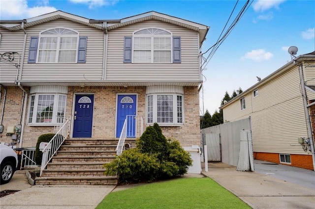 townhome / multi-family property with brick siding