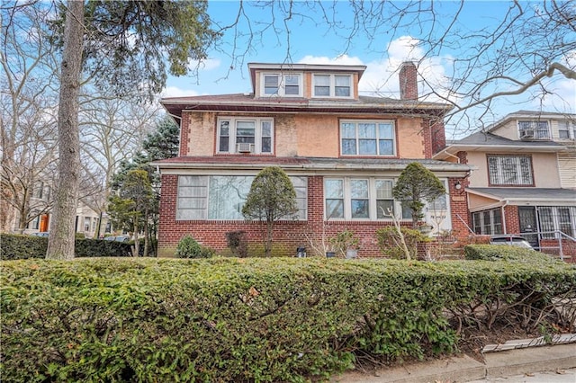 traditional style home with brick siding and a chimney